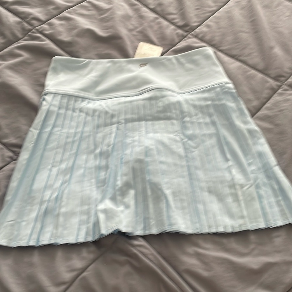 Fabletics pleaded tennis skirt with shorts underneath. Size medium.